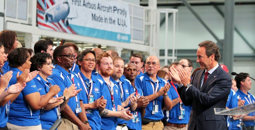 Fabrice Bregier, Airbus President and CEO, applauds Airbus employees at the grand opening. (Mike Kittrell/Alabama NewsCenter)