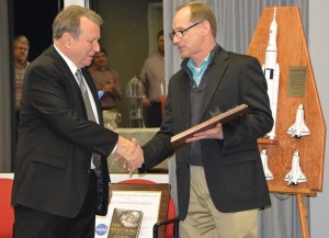 NASA’s Tim Lawrence presents Southern Research’s John Koenig with an honorary award for his contributions to space flight.