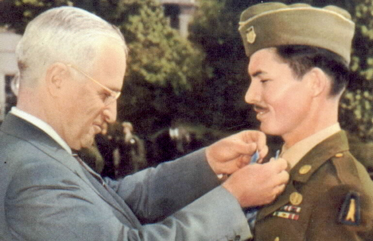 President Harry Truman hangs the Medal of Honor around Cpl. Desmond Doss's neck. 