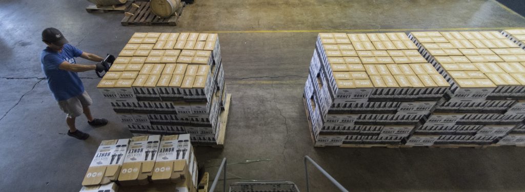 Efe Orgen moves freshly bottled beer at the Back Forty Beer Co. in Gadsden. (Bernard Troncale / Alabama NewsCenter)